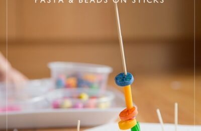 Set up an invitation to play using pasta an beads on sticks.