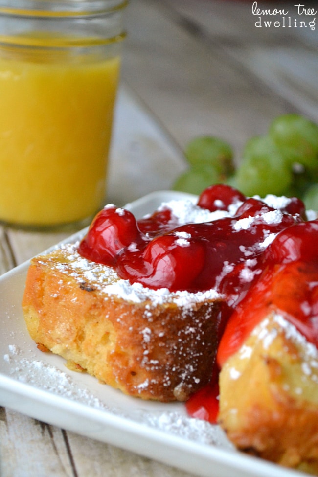Pound Cake French Toast topped with cherry pie filling and powdered sugar. The BEST Christmas breakfast!