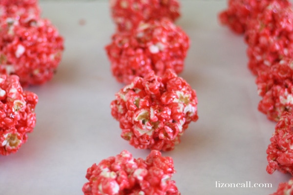 these jello popcorn balls are super fun to make with the kids and they taste yummy too! Great summer activity.
