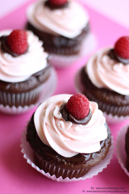 Perfect for Valentine's Day, these decadent chocolate cupcakes are topped with ganache and raspberry buttercream frosting. Get the recipe on the blog today! www.orsoshesays.com