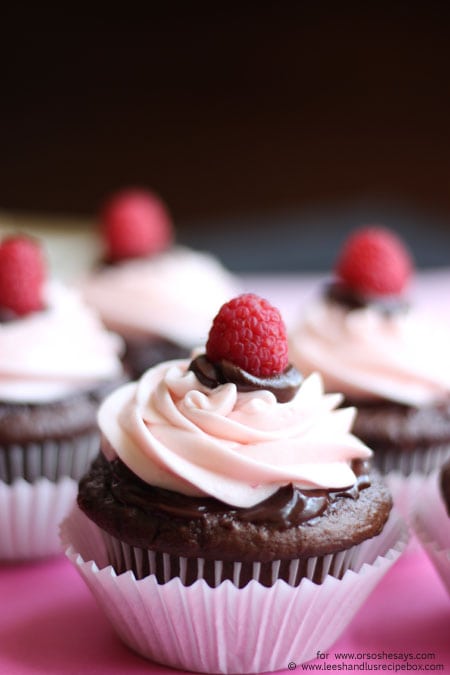 Perfect for Valentine's Day, these decadent chocolate cupcakes are topped with ganache and raspberry buttercream frosting. Get the recipe on the blog today! www.orsoshesays.com