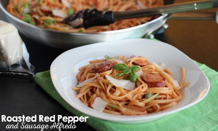 Roasted red pepper and sausage alfredo is a crowd-pleaser! Check out the recipe today on www.orsoshesays.com.