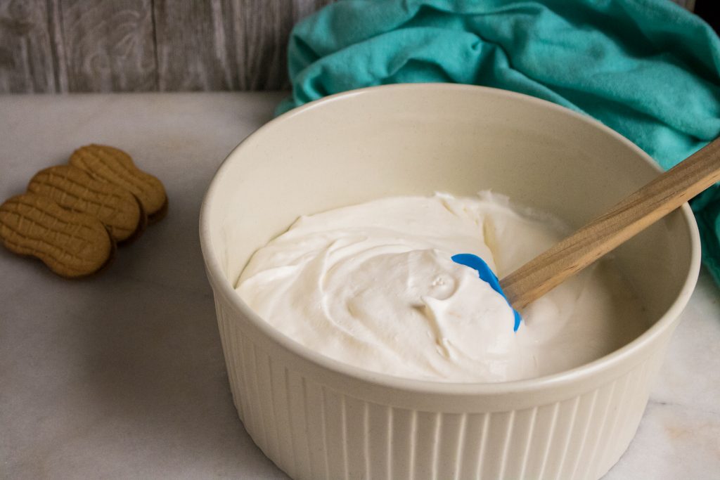 Nutter Butters add a great flavor to this no-churn ice cream. Enjoy one last summer hurrah with crumbled cookies layered between sheets of ice cream. #icecream #dessert #nutterbutters #cookies #summer #recipe #osss #orsoshesays #mormonblogger #mormon #ldsblogger #lds